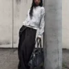 Pantalones plisados con doble botón Pantalones plisados con doble botón