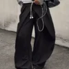 Pantalones plisados con doble botón Pantalones plisados con doble botón